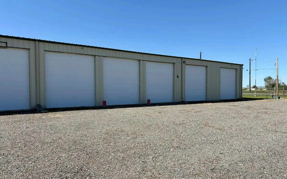 Metal commercial storage building with a row of roll-up doors