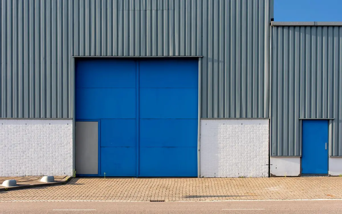 Steel-clad commercial building with a large sliding door